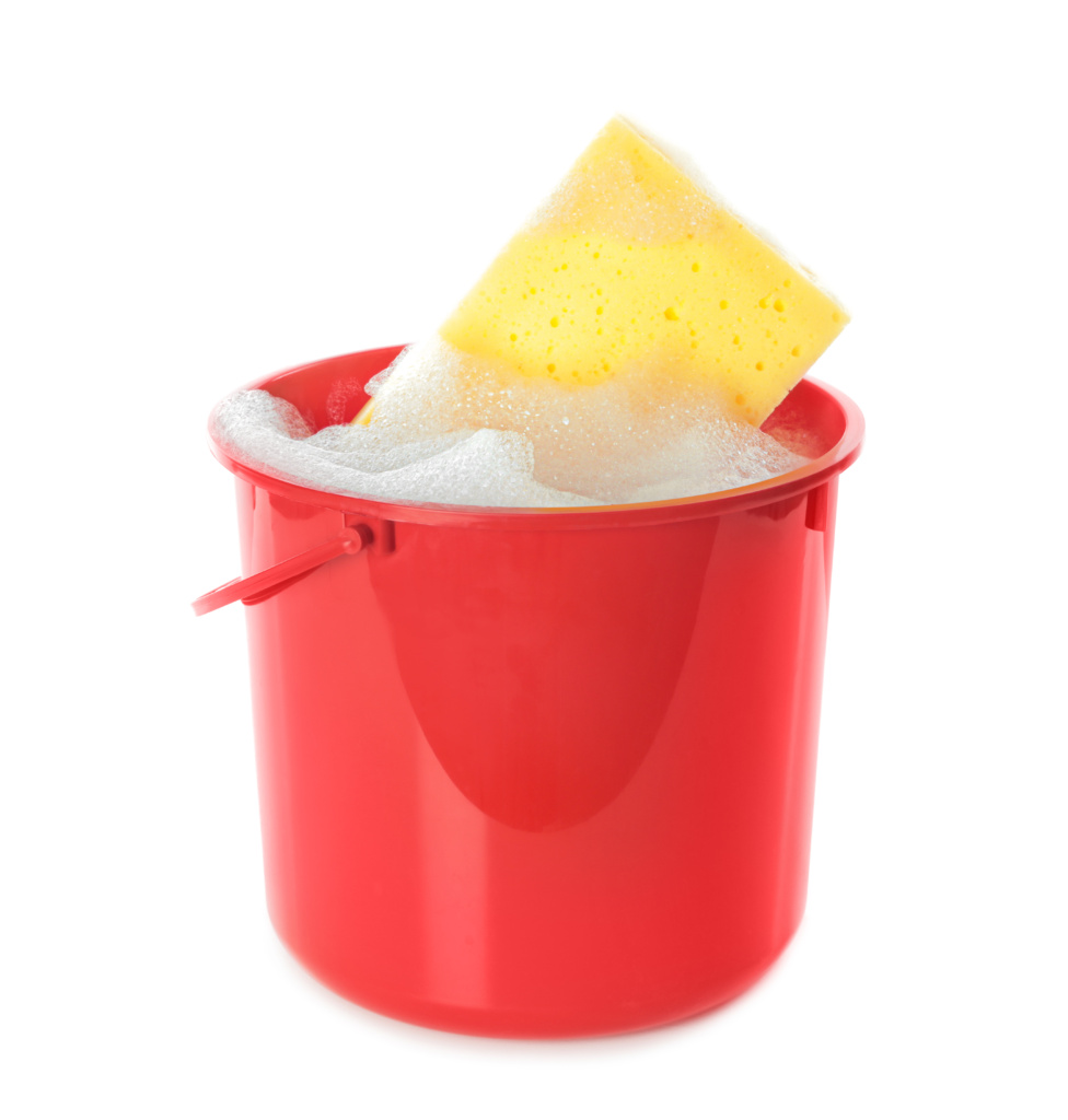 Red plastic bucket with sponge and soapy water to clean a tarp